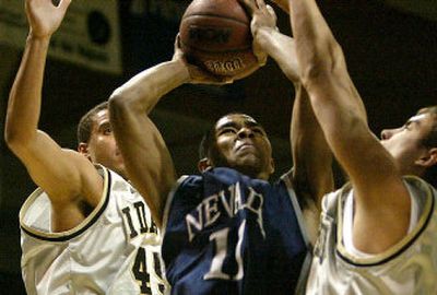 
Nevada guard Ramon Sessions attempts to shoot between Idaho's David Dubois, left, and Matt Forge in Monday's game at Moscow. 
 (Associated Press / The Spokesman-Review)