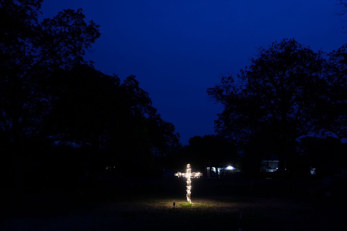 FILE - A cross stands in the yard near Robb Elementary School in Uvalde, Texas, Wednesday, June 1, 2022. On May 24, 2022, an 18-year-old entered the school and fatally shot several children and teachers.  (Jae C. Hong)