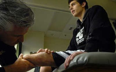 
Physical therapist Brad Sharples examines Brett Smrz after a session at North Idaho Physical Therapy  on March 19.
 (The Spokesman-Review)