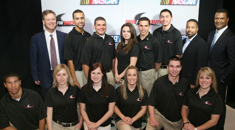 Back row, from left, NASCAR CEO Brian France, Michael Cherry, Ryan Gifford, Jessica Brunelli, Paulie Harraka, Sergio Pena, Revolution Racing president Max Siegel, and NASCAR Managing Director of Public Affairs Marcus Jadotte. Front row, from left, Darrell Wallace Jr., Rebecca Kasten, Megan Reitenour, Katie Hagar, Jason Romero and Mackena Bell. (Photo courtesy of Getty Images)