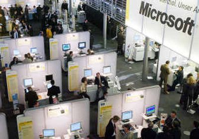 
People visit the stand of U.S. software company Microsoft at the Cebit 2004 computer fair in Hanover, northern Germany, earlier this year. 
 (Associated Press / The Spokesman-Review)