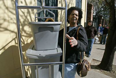 
Pauline Powell removes personal belongings from the Maison St. Charles Hotel in New Orleans on Saturday. Powell and her family were among about 100 people who received eviction notices. The evictions were blocked by a judge. 
 (Associated Press / The Spokesman-Review)