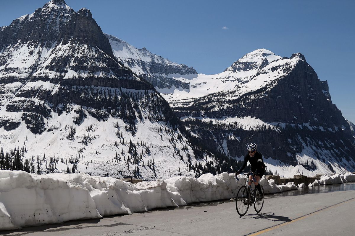 A cyclist rides the Going-to-the-Sun Road in Glacier National Park during springtime before it opens to automobile traffic. (John  Nelson / The Spokesman-Review)