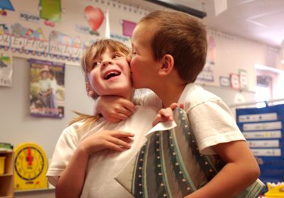 Timothy Woofter, 6, right, plants a kiss on the cheek of twin sister, Tori Woofter, at Miami-Yoder School in Rush, Colo. Increasing, parents are insisting twins be placed in classes together. McClatchy Tribune (McClatchy Tribune / The Spokesman-Review)
