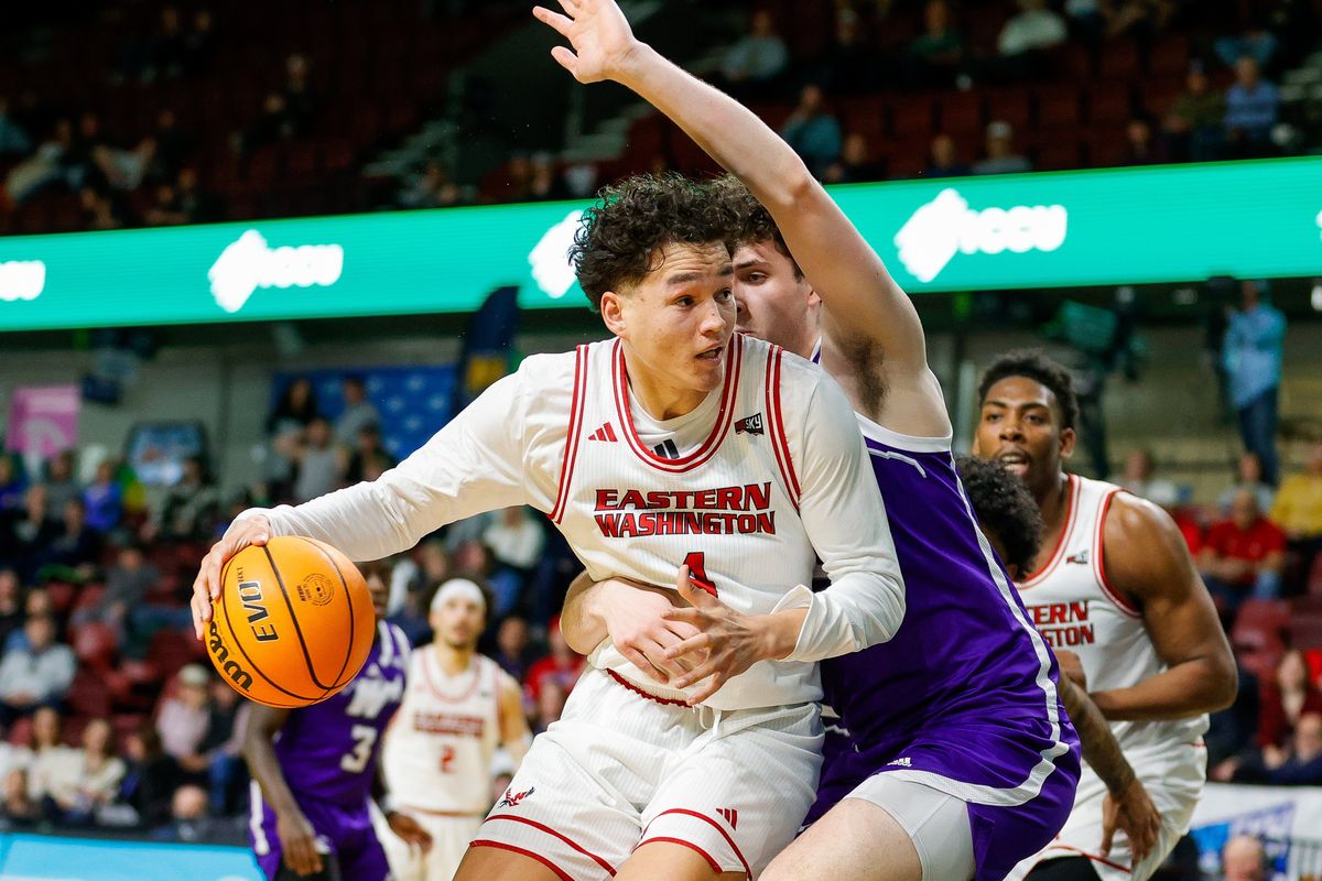 Eastern Washington forward Alton Hamilton IV (4) battles to the basket as he is wrapped up by a Weber State defender during their matchup in the Big Sky Basketball tournament at the ICCU Arena in Boise, Idaho. Photo by Steve Conner  (Steve Conner)