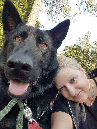 Laura Renz and her former service dog, Vinny. The dog had to be pulled from service after he was rushed too many times by “imposter” service dogs and became too reactive, she says. (COURTESY)