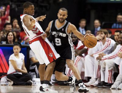 Toronto’s Kyle Lowry, left, tries in vain to defend San Antonio's Tony Parker, who had 32 points in a Spurs’ victory. (Associated Press)