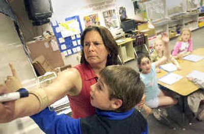 
Fernan Elementary School teacher Pam Kiefer and student Clayton Gersten work on a fractions problem Thursday during a math session for kids who excel in the subject. 
 (Jesse Tinsley / The Spokesman-Review)