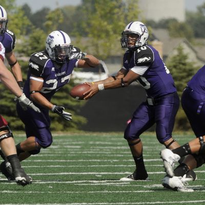 Lorenzo Brown hands off to Ryan Lowmillwer for the potent Sioux Falls offense.  (Associated Press / The Spokesman-Review)