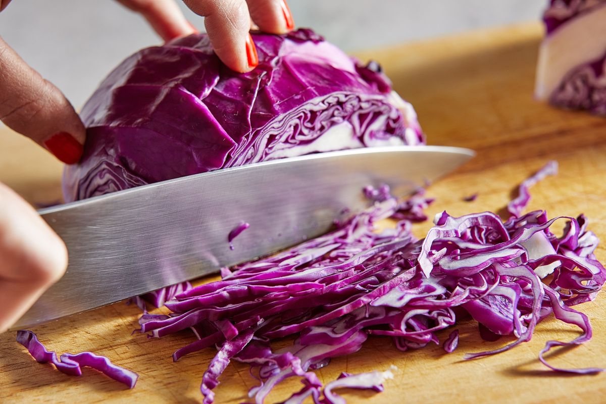 Both red and green cabbages are cut into fine, thin ribbons.  (Tom McCorkle/The Washington Post)