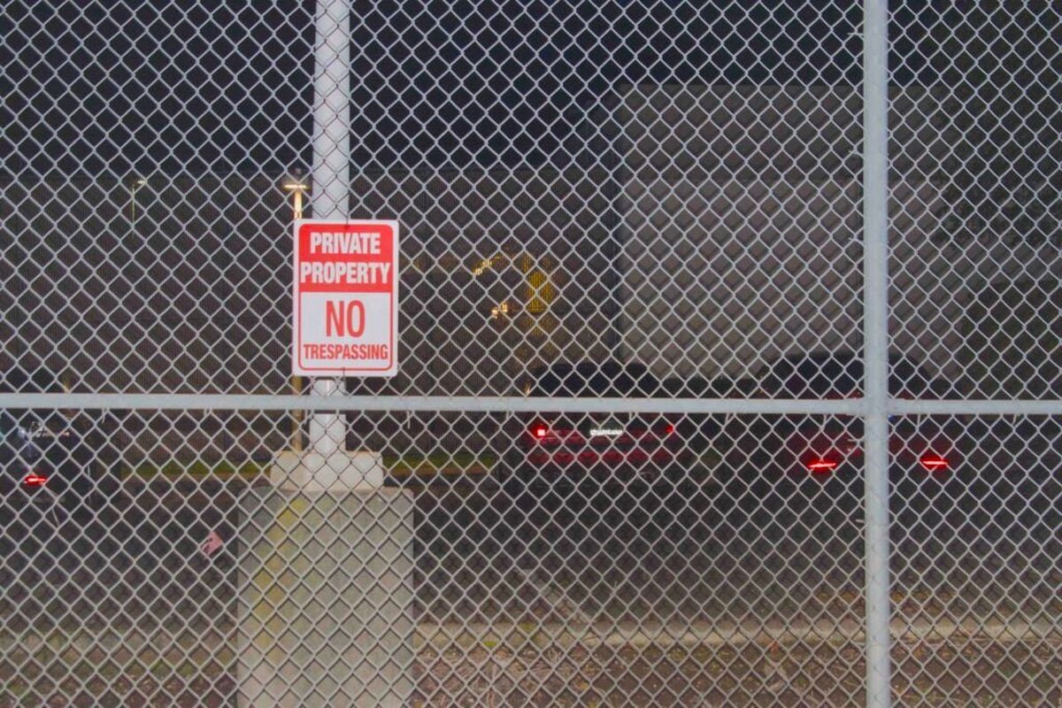A “no trespassing” sign on a fence outside the Northwest Detention Center.  (Grace Deng/Washington State Standard)
