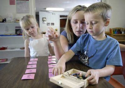 Meredith Lombardi, owner of Spokane Montessori on North Wall Street, plays a game of