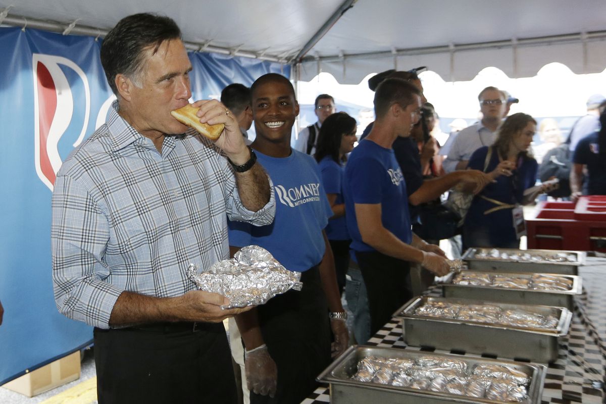 Republican presidential candidate Mitt Romney takes a bite out of a hot dog as he campaigns at the Federated Auto Parts 400 NASCAR Sprint Cup Series race at Richmond International Raceway in Richmond, Va., Saturday, Sept. 8, 2012. (Charles Dharapak / Associated Press)