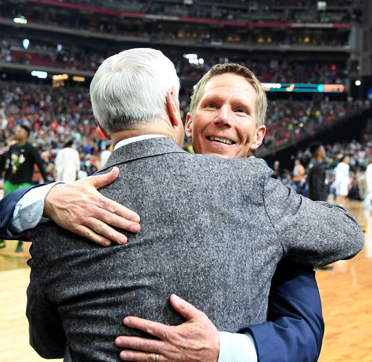After beating South Carolina 77-73, Gonzaga head coach Mark Few hugs North Carolina coach Roy Williams who was coming onto the court for the Tar Heels’ game against Oregon on Saturday in Phoenix. (Colin Mulvany / The Spokesman-Review)