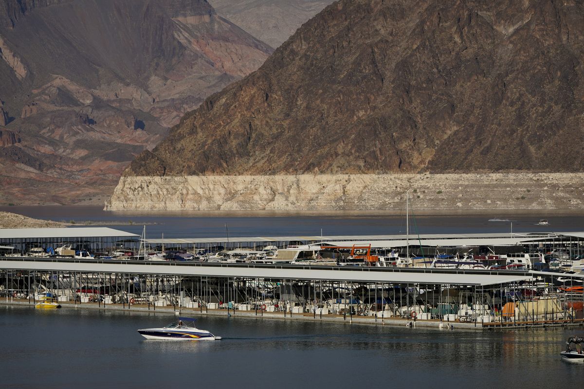 In this Aug. 13, 2020 photo, a bathtub ring of light minerals delineates the high water mark on Lake Mead at the Lake Mead National Recreation Area, near Boulder City, Nev. The Bureau of Reclamation is forecasting first-ever water shortages because of falling levels at Lake Mead and says the reservoir could drop so low that it might not be able to generate electricity at Hoover Dam.  (John Locher)