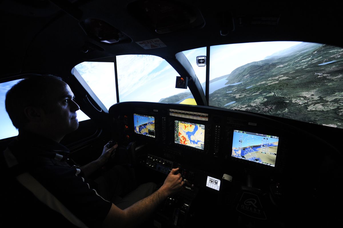Ken Smoll, director of training at Spokane Turbine Center, banks STC’s flight simulator over a digital version of Lake Pend Oreille on Tuesday at STC’s training facility at Felts Field. The simulator is part of the training for missionary pilots. (Jesse Tinsley)