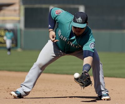 Seattle Mariners first baseman Daniel Vogelbach fields a ball during a Spring Training game. (Chris Carlson / Associated Press)