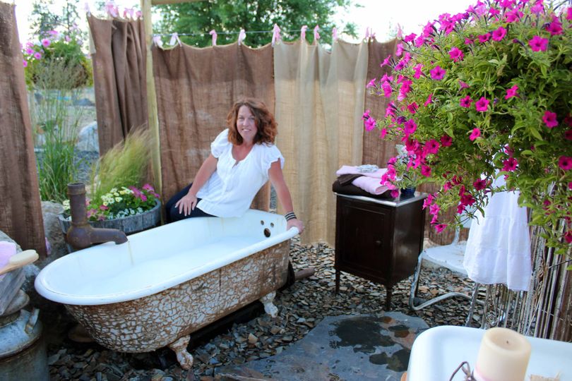 Kelly Tareski shows off the outdoor bathing suite on her Nine Mile Falls property near Spokane. (Cheryl-Anne Millsap / Photo by Cheryl-Anne Millsap)