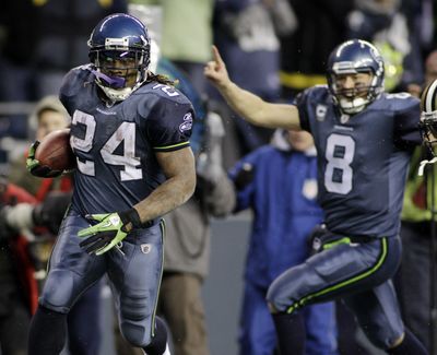 Matt Hasselbeck, right, celebrates as Marshawn Lynch scores on a 67-yard touchdown run that has become part of Seahawks lore.  (Associated Press)