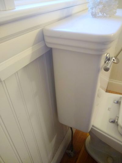 The gap you see between the toilet tank and the wall should be shimmed if you want to lean back against the tank (Tim Carter)