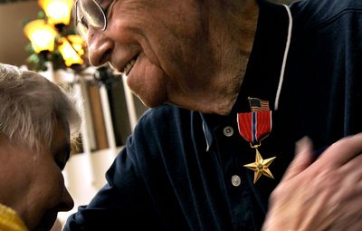 Leroy Berry, 90,  gets a hug after receiving the Bronze Star at Bestland Retirement Community in Coeur d’Alene on Monday. Berry’s grandson discovered the World War II veteran’s eligibility for the medal while researching his service. (Kathy Plonka / The Spokesman-Review)