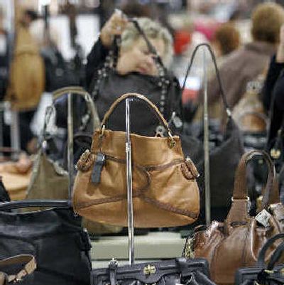 
A shopper looks at a bag on sale at Bloomingdale's in NewYork on Monday. 
 (Associated Press / The Spokesman-Review)