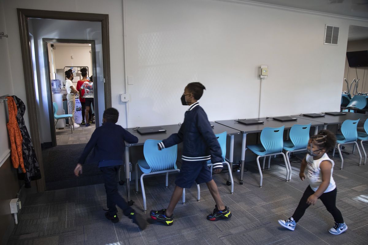 In this Friday, Oct. 1, 2021 photo, from left, Zihare Wellons, 7, Shahif Wellons, 12, and Janiyah Acie, 3 walk through new Rec2Tech space at Jefferson Recreation Center, which will provide access to technology and innovative programming for community members including STEM, computer science and coding education, combined with the arts in Pittsburgh. The city plans to use some of the money from the American Rescue Plan, passed by Congress last spring, to continue expanding these programs. Initial programming will be for young people, with plans to grow the programming into the broader community.  (Rebecca Droke)