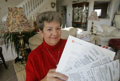 
Kathy Meyers holds her past natual gas bills in her living room in Westerville, Ohio, on Tuesday. In July, Meyers signed a two-year contract with Direct Energy to pay $11.30 per 1,000 cubic feet. In contrast, her local utility, Columbia Gas and Electric, is currently charging $12.91 per 1,000 cubic feet. 
 (Associated Press / The Spokesman-Review)