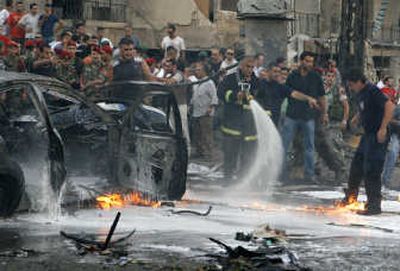 
A firefighter tries to extinguish a burning car in Beirut, Lebanon, on Wednesday after a bomb blast killed an anti-Syrian parliament member and at least eight others. Associated Press
 (Associated Press / The Spokesman-Review)