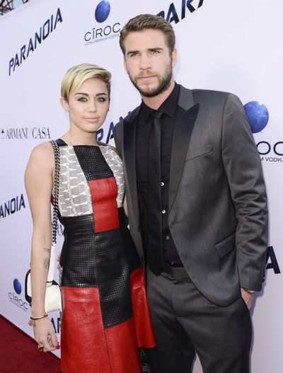 Miley Cyrus and her fiance Liam Hemsworth, shown in 2013, visited a San Diego children’s hospital on Thursday. The visit was in conjunction with Cyrus’ Happy Hippie Foundation, which aims to help homeless and LGBT youth, and other vulnerable groups. (Dan Steinberg / Invision/AP)