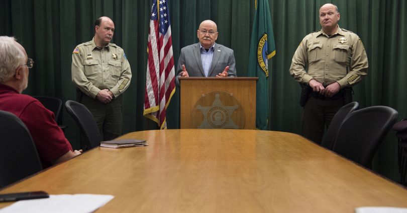 Spokane Valley mayor Rod Higgins speaks to the media flanked by Spokane Valley Police Chief Rick VanLeuven, left, and Sheriff Ozzie Knezovich during a press conference discussing the City of Spokane Valley’s law enforcement contract with the Sheriffs Office on Friday, Feb. 26, 2016, at the Public Safety Building in the Sheriffs Office Conference Room in Spokane. (Tyler Tjomsland)