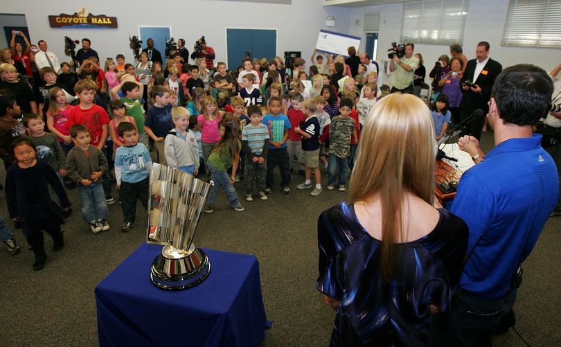 With the Tiffany Chase for the NASCAR Sprint Cup trophy, four-time NASCAR Sprint Cup Champion Jimmie Johnson, driver of the No. 48 Lowe's Chevrolet, and his wife Chandra meet with students at his alma mater, Crest Elementary School on Monday in El Cajon, Calif. (Photo Credit: Todd Warshaw/Getty Images for NASCAR) (Todd Warshaw / Getty Images North America)