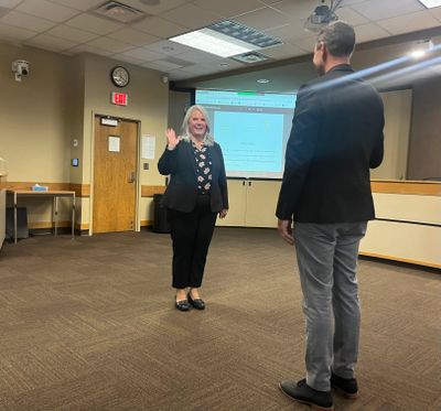 Spokane Public Schools' newest board member Hilary Kozel reciting her oath of office from Superintendent Adam Swinyard.   (Elena Perry/THE SPOKESMAN-REVIEW)