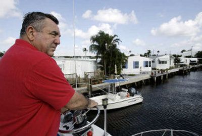 
John Sideris sails his boat into the canal in the back of his mobile home on the Intracoastal Waterway in Briny Breezes, Fla. Briny Breezes' board recently approved the sale of this  oceanside hamlet of 488 mobile homes  for $510 million. Shareholders have until Jan. 10 to ratify or reject the deal. 
 (Associated Press / The Spokesman-Review)