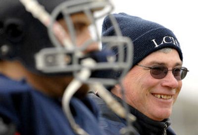
Lake City High School football coach Van Troxel shares a laugh with his players during practice at the school in Coeur d'Alene on Tuesday. He puts less emphasis on winning and more emphasis on getting stronger and learning the system. 
 (Kathy Plonka / The Spokesman-Review)