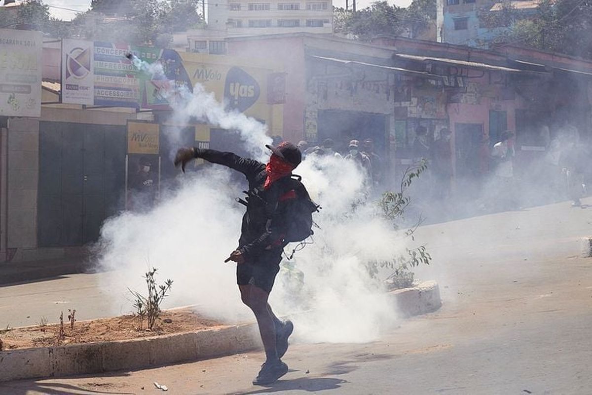 A protester throws back a tear gas canister lobbed by Malagasy riot police during a demonstration denouncing frequent power outages and water shortages, near the University of Antananarivo, Madagascar, Monday.   (Reuters )