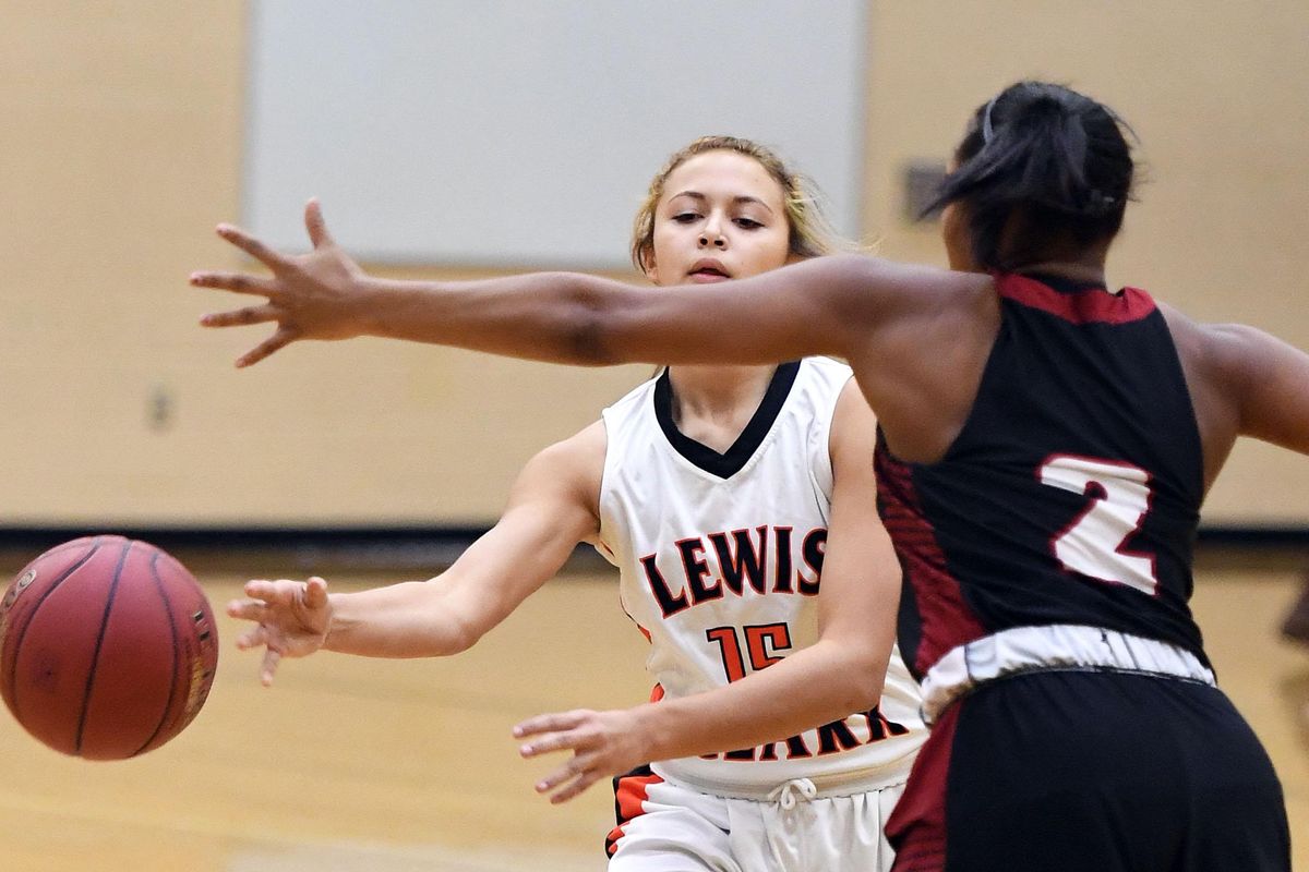 Lewis and Clark Peyton Howard (15) makes a pass around North Central Sativa Rogers (2) during a GSL high school girls basketball game, Tues., Nov. 29, 2016, at Lewis and Clark High School. (Colin Mulvany / The Spokesman-Review)