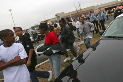 
Police officers escort people from the Brookdale Center Mall in Brooklyn Center, Minn., after a melee broke out Saturday during a concert by the boy band B5, which was playing inside. 
 (Associated Press / The Spokesman-Review)