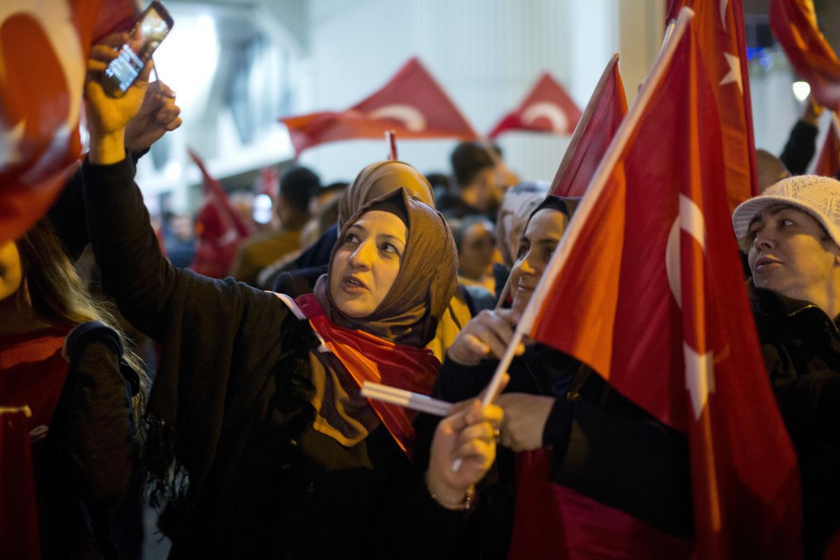 Demonstrators wave turkish flags outside the Turkish consulate in Rotterdam, Netherlands, Saturday. Turkish Foreign Minister Mevlut Cavusoglu was due to visit Rotterdam on Saturday to campaign for a referendum next month on constitutional reforms in Turkey. The Dutch government says that it withdrew the permission for Cavusoglu