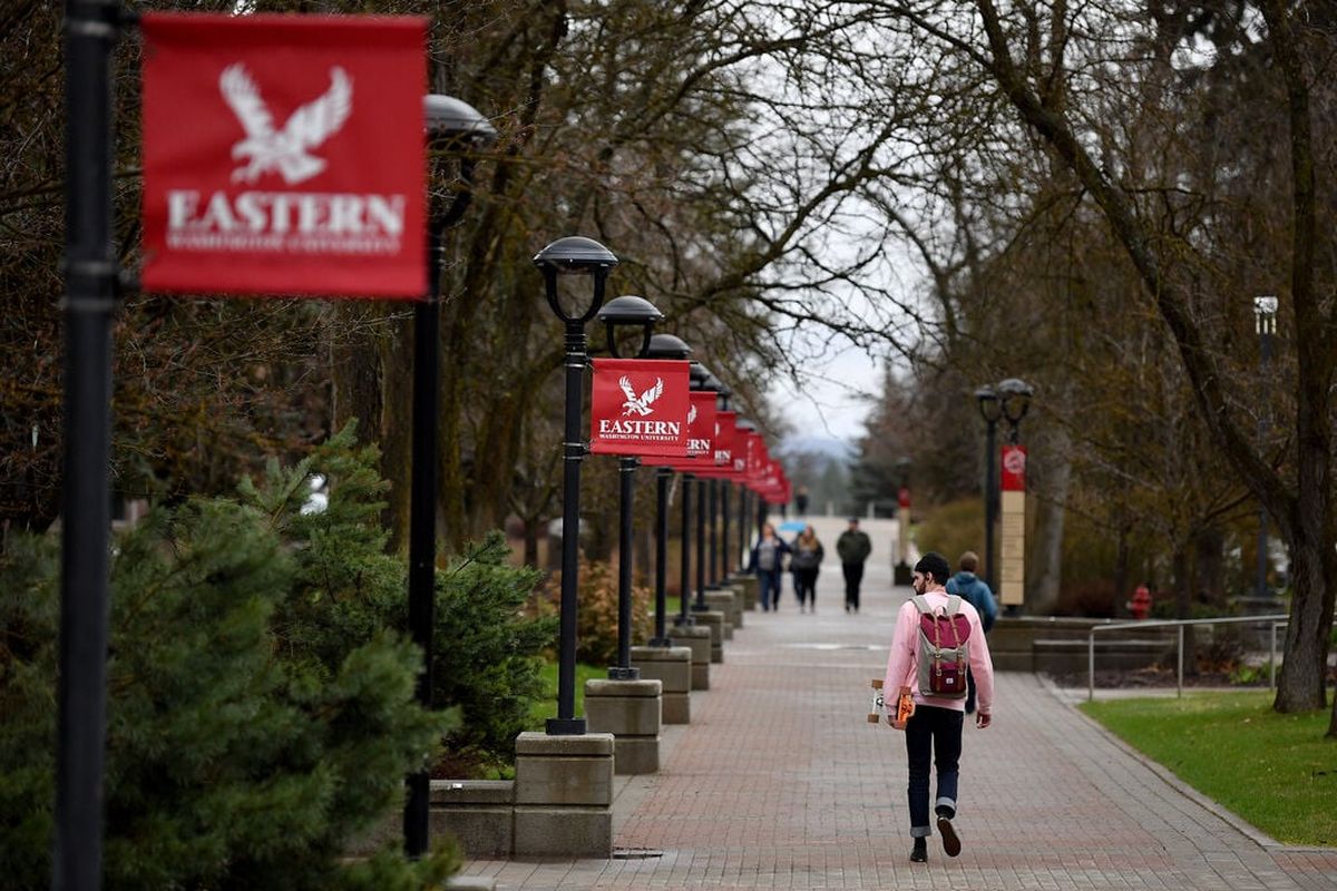 Students walk through Eastern Washington University’s campus between classes in this April 2019 photo.  (TYLER TJOMSLAND)