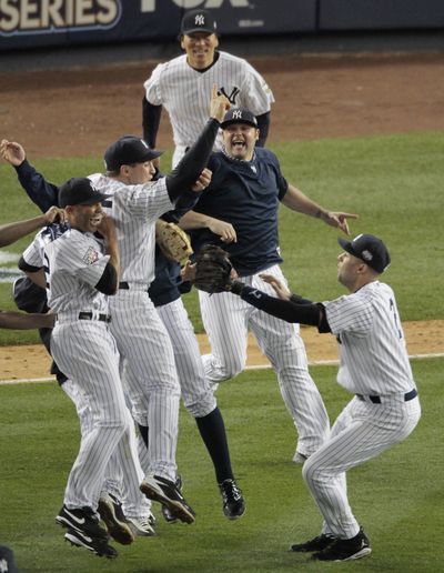 Yankees' Derek Jeter, lower right, and teammates celebrate after winning the   World Series against the Philadelphia Phillies. (Peter Morgan / The Spokesman-Review)