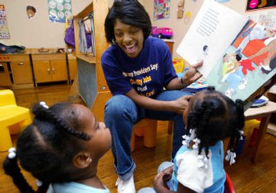 
Child-care worker Angenita Tanner reads to preschoolers at home in Chicago.
 (Associated Press / The Spokesman-Review)