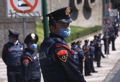 Riot police stand in front of Mexico’s National Autonomous University soccer stadium, which was closed to the public, shortly before a game with Chivas in Mexico City on Sunday.  (Associated Press / The Spokesman-Review)