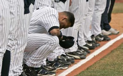 
New York Yankees shortstop Derek Jeter takes a moment for a prayer during opening ceremonies prior to playing Virginia Tech. Associated Press
 (Associated Press / The Spokesman-Review)