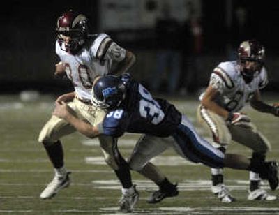 
University High running back, No. 30 Tyler Carlson, tries to outrun G-Prep's Galen Duff during the Bullpups season home opener  Sept. This season, Carlson has rushed for 568 yards and four touchdowns on 102 carries and leads the league in rushing.
 (Jed Conklin / The Spokesman-Review)