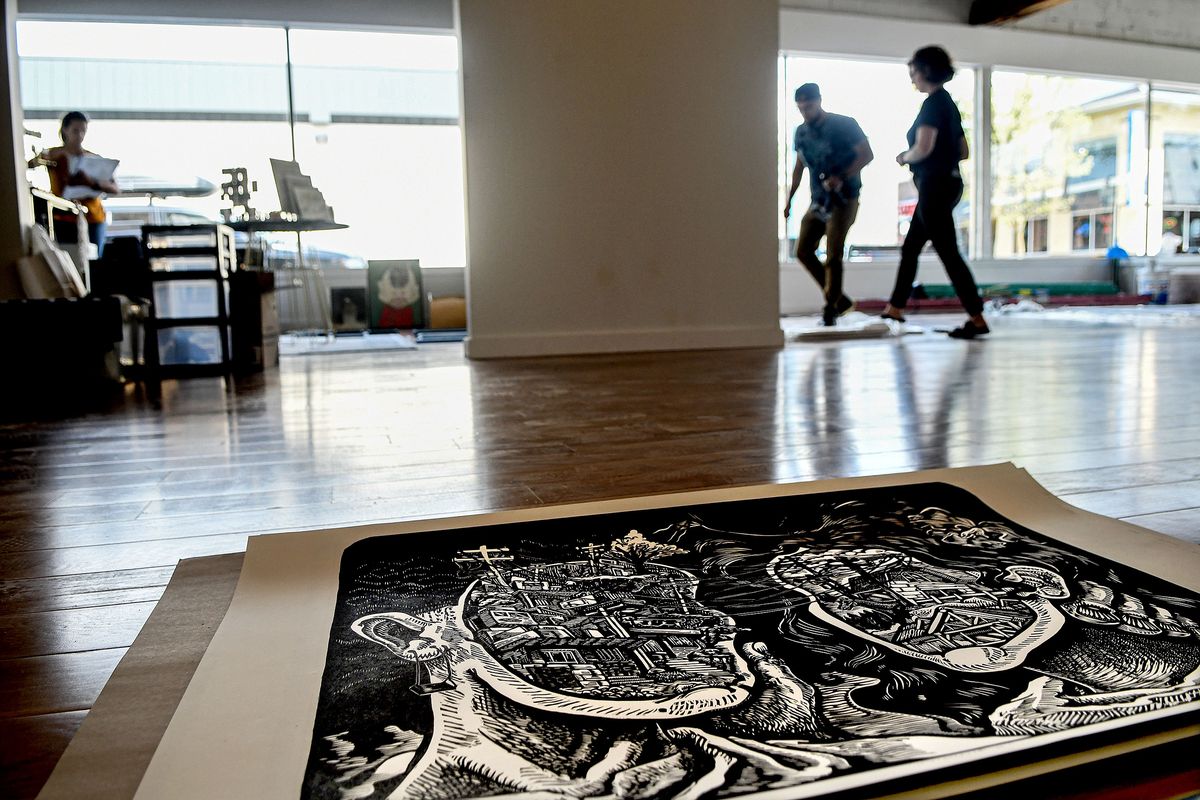 A print titled “Encuentro” by artist Reinaldo Gil Zambrano is ready for display at Emerge CDA on Tuesday while work continues in preparation for Friday’s opening in Coeur d’Alene.  (Kathy Plonka/The Spokesman-Review)