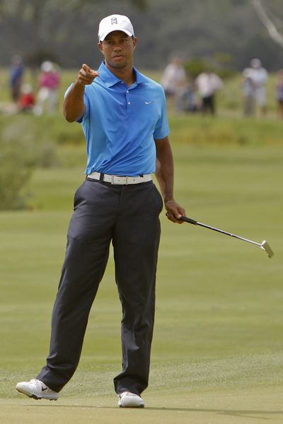 Tiger Woods reacts to his birdie putt on fourth hole. (Associated Press)