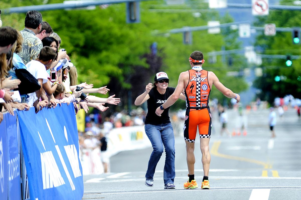 Ben Hoffman’s girlfriend, Kelsey, rushes to embrace him after he won the 2013 Coeur d’Alene Ironman triathlon in record time on Sunday. (TYLER TJOMSLAND photos)