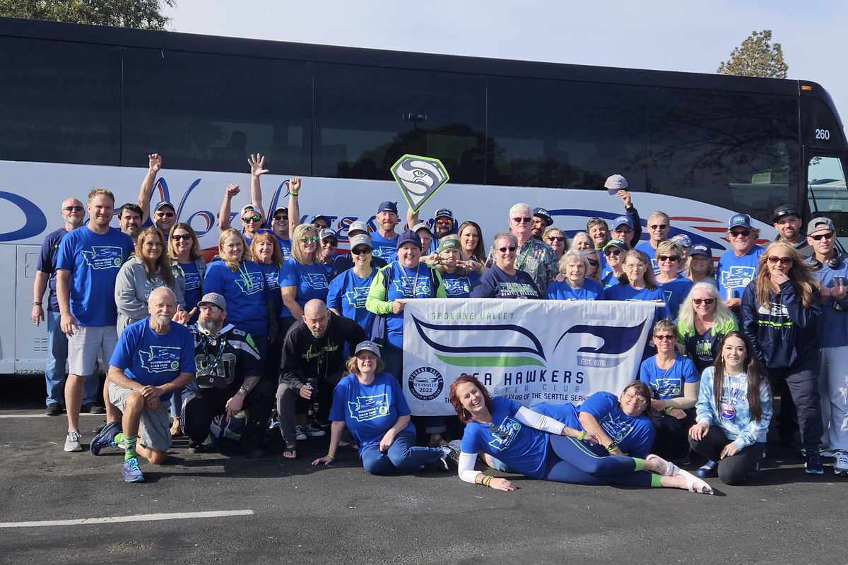 The Spokane Valley Sea Hawkers gather in front of a bus before a trip to watch the Seattle Seahawks play in Seattle.  (Courtesy of Pat O