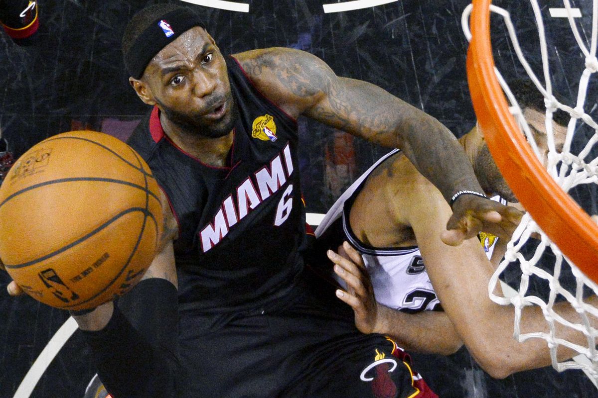 Miami’s LeBron James, who scored 35 points and had 10 rebounds in a Game 2 victory over San Antonio Sunday night, soars to the basket over Spurs’ Tim Duncan. (Associated Press)